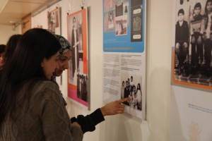 Women look at the She Settles in the Shields exhibition at Community Launch in 2011