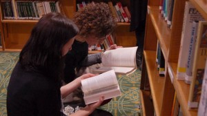 Librarian and artist looking through collection for inspiration