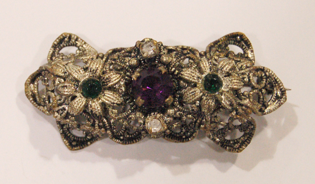 Suffragette brooch with floral patterns in silver with green, purple and clear stones