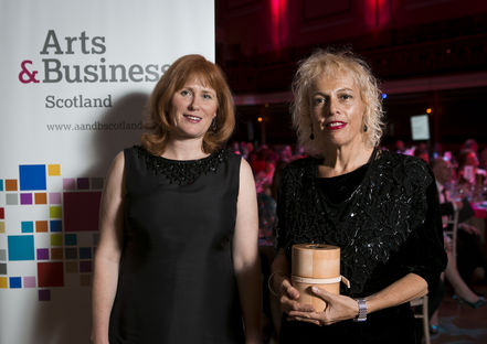 GWL's Adele Patrick accepts the Arts & Business Scotland Enterprising Museum Award 2013-14 from Joanne Orr, CEO of Museums Galleries Scotland.