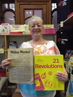 Anne Marie Shields holds up a copy of 21 Revolutions and The Woman Worker which inspired her blog post.