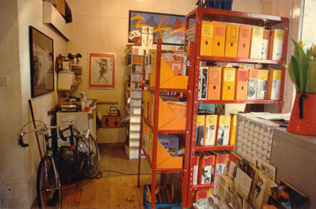 Red metal shelves filled with orange magazine holders in GWL's first premises on Hill Street, Garnethill, 1991. Photo: Adele Patrick, GWL collection.