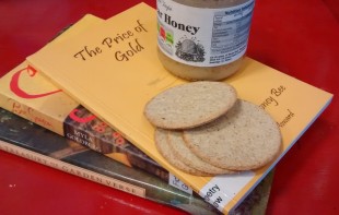 Photo of books, a honey jar and oat cakes.