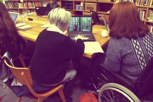 Louisina and Claire working together on a laptop