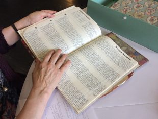 Close up of a farming diary being investigated by the Community Curators