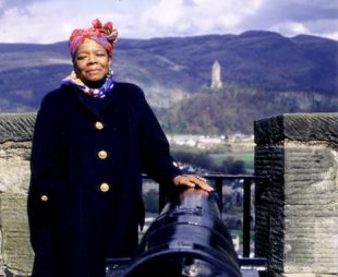 Photo of Dr Maya Angelou standing at Stirling Castle with Wallace Monument in the background.