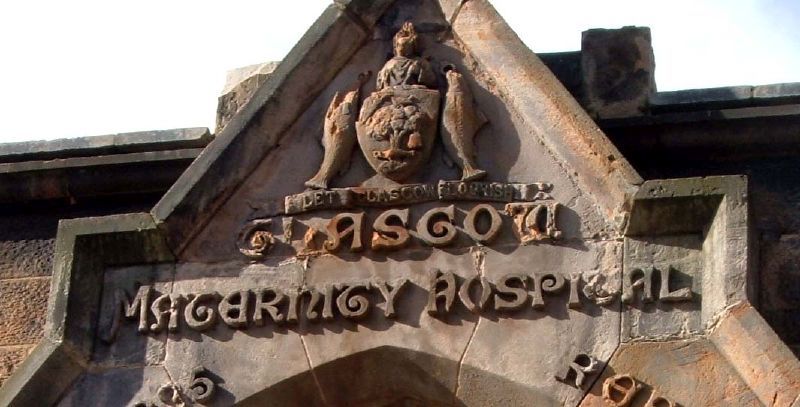 Close up of a sign for Glasgow Maternity Hospital, carved in stone.