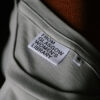 Close up of the labels on the 'From Glasgow Women's Library' t-shirts. The text says 'From Glasgow Women's Library'.