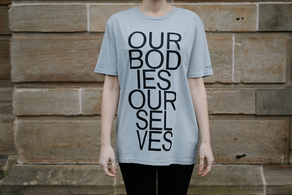 Grey t-shirt with 'Our Bodies Ourselves' emblazoned on the front
