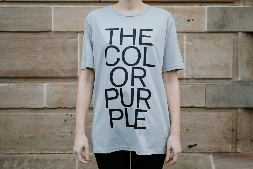 Grey t-shirt emblazoned with 'The Color Purple'