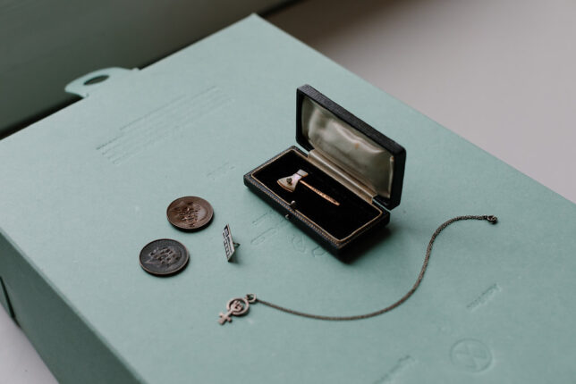 Feminist Charms Archive inspirations including a Carry A Nation Axe pin and a Suffragette Coin