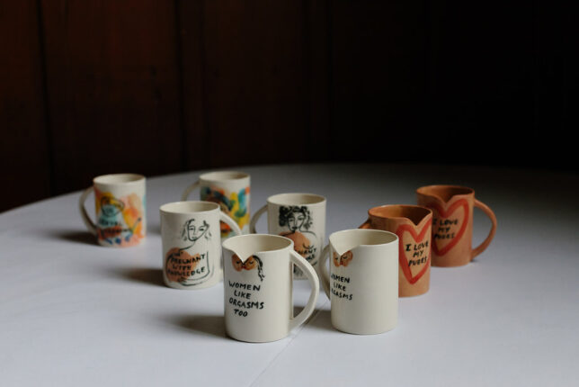 Slogan Mugs all displayed on a table