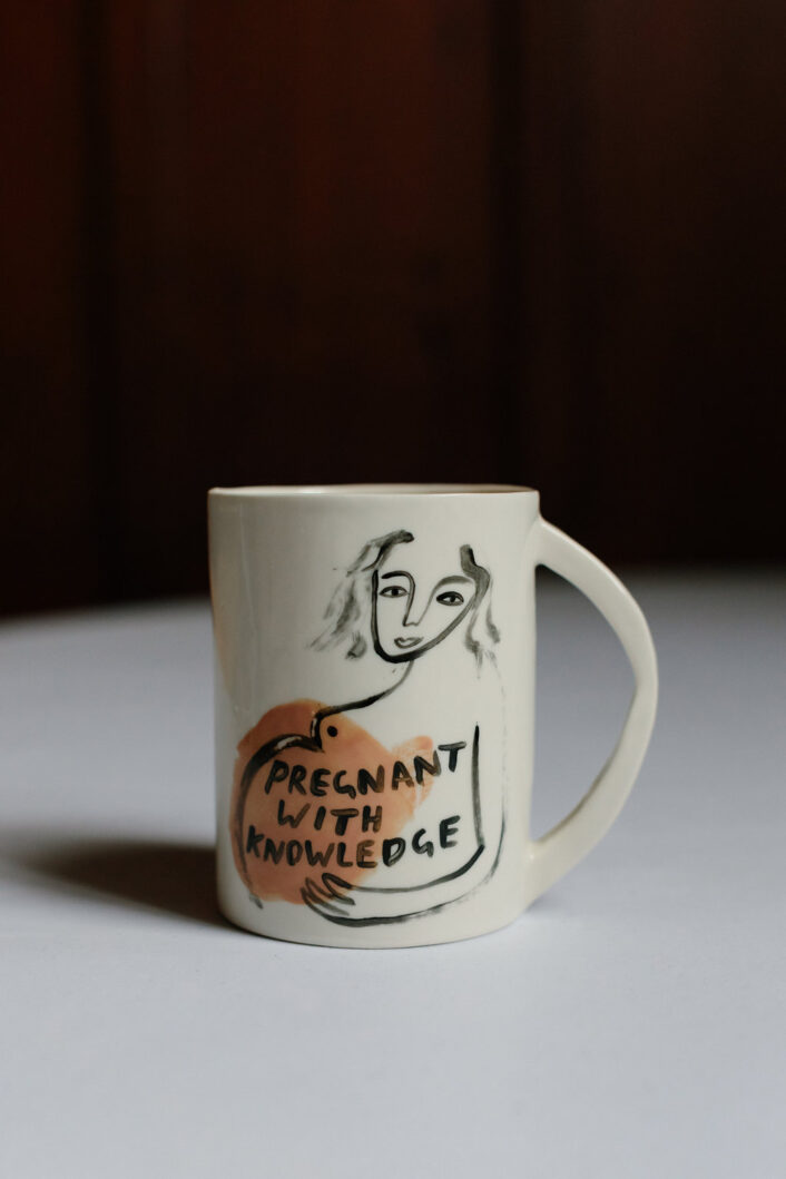 Pregnant with Knowledge Mug. It shows a pregnant figure