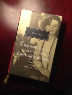 Photograph of the Everyman’s Library edition Muriel Spark book mentioned in the blog post. The cover shows a black and white image of a woman, possibly Spark, and the tail end of the yellow ribbon is poking out of the bottom of the book.