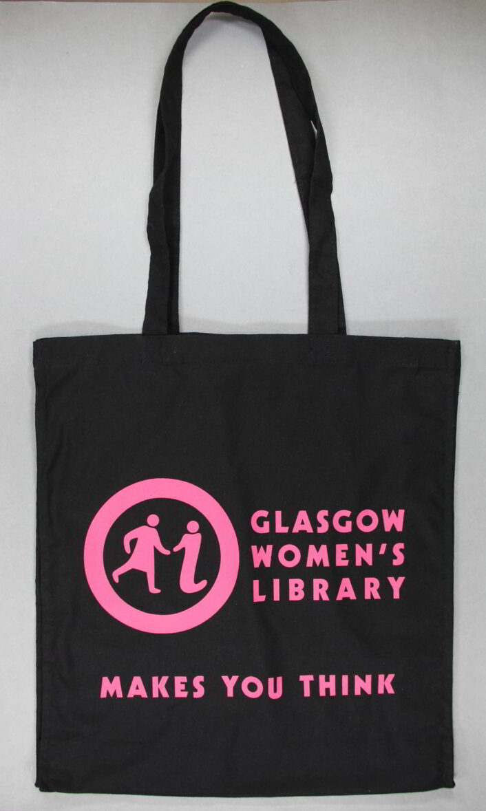 Black tote bag with bright pink text on it. It says 'Glasgow Women's Library' and 'Makes You Think' on it.