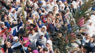 Photograph showing a crowd of Palestinian women on a street rally 