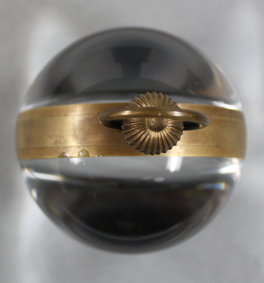 Paperweight clock seen from above to show its spherical shape