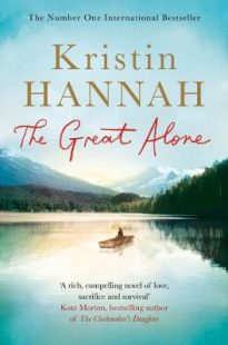 Cover of The Great Alone by Kristin Hannah. A small boat with a single passenger floating on a great lake with mountains rising in the background. Trees surround the lake and cast a shadow on the lake. 