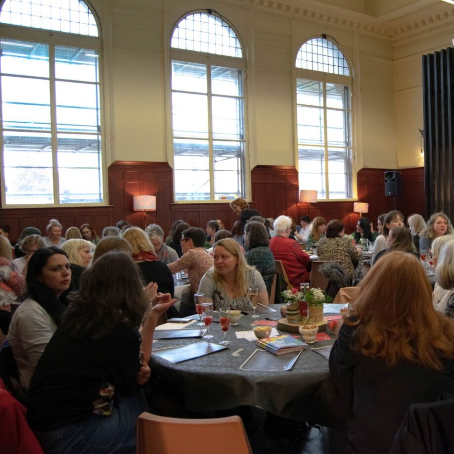 Women sitting around tables talking
