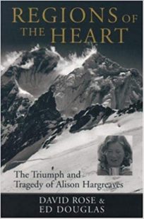 The cover of Region of the Hearts is in black and white with a mountain in the background with cloudes above. A picture of Alison Hargreaves accompanied by the subtitle of the book " The Triumph and Tragedy of Alison Hargreaves" in black letters.