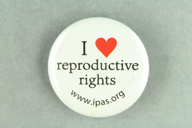 A white badge with the text, "I heart reproductive rights, www.ipas.org."