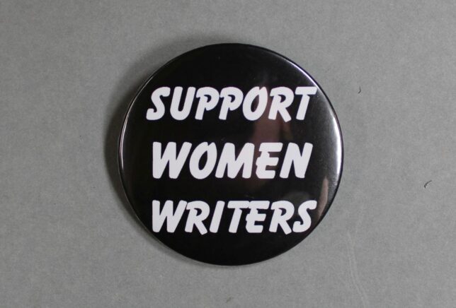 A black badge with the text, "Support Women Writers", printed in white.