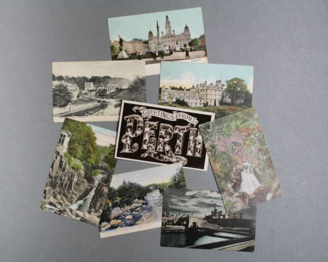 Postcards from the collection showing different buildings and landscape, including a "Greetings From Fife" postcard in the centre.