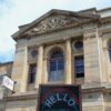 A photo of the front of GWL, with a blackboard sign saying 'Hello, Everyone Welcome' in front.