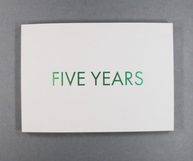 Five Years book cover. The cover is white, with the title in metallic green lettering