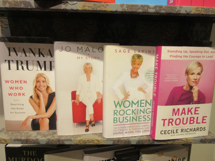 Detail of book covers, women and leadership display on shelf at Waterstones Glasgow: white, blonde, pink and power themed.
