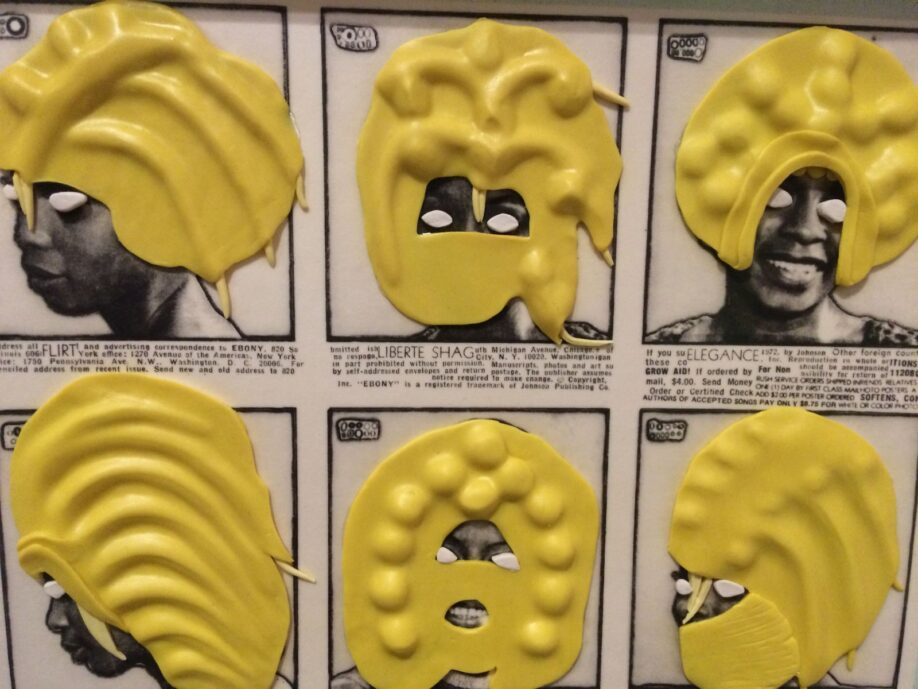 Detail of work by Ellen Gallagher, DeLuxe, 2004-5, images with plasticine. The work features black and white photos of black women taken from vintage adverts, which have then had their eyes covered in white plasticine and their hair (and sometimes faces) covered in yellow plasticine.