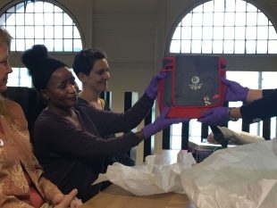 On the archive mezzanine at GWL, some of the community curators hold up a Glasgow 2014 branded bag, part of our Women in Sport collection