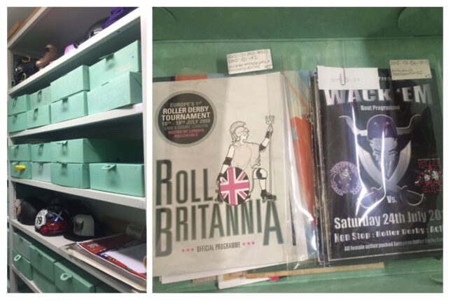 On the left, a a bay of shelves filled with green boxes and roller derby material, including helmets. On the right, a box filled with roller derby bout programmes; the top two are titled Roll Britannia and Wack 'Em.