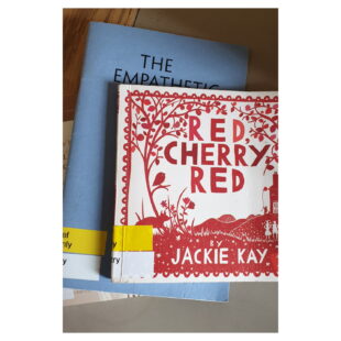 Jackie Kay's Red Cherry Red sits atop a pile of books