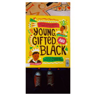 a bright yellow book cover with colourful illustrations. the book is "Young Gifted and Black" 