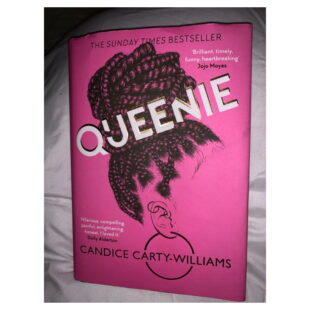 the book "Queenie" is bright pink with the outline of a woman's face and hair