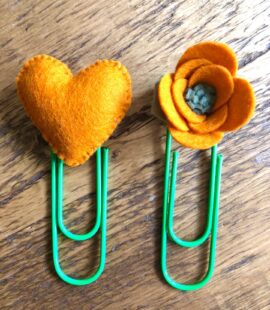 A yellow felt heart and a yellow felt flower have been added to two paperclips. Craft created by Purple Bee.