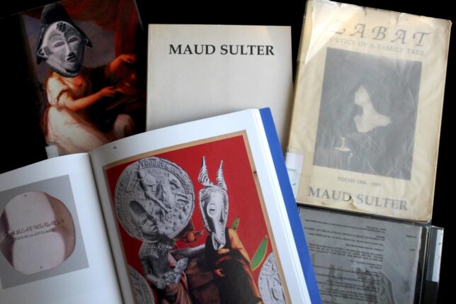 A selection of books by Maud Sulter overlaid on a table. Some books are open showing collage and photography by Maud Sulter.