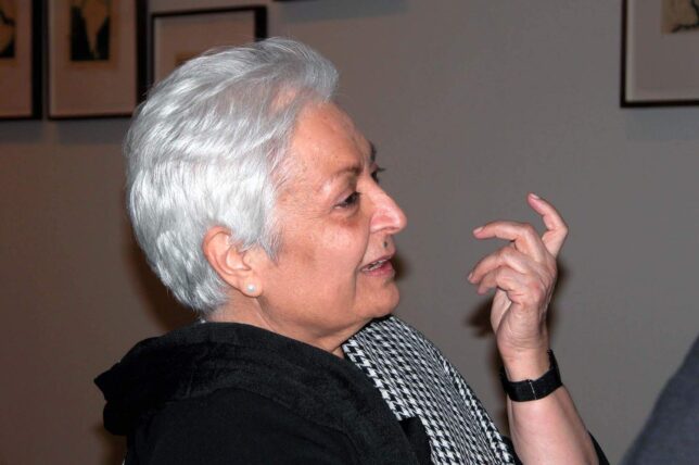 Portrait of Zarina Hashmi. The portrait shows Zarina's side profile, she is gesturing with her hand and smiling