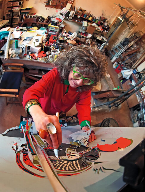 Edith Simon in her studio working on a scalpel painting