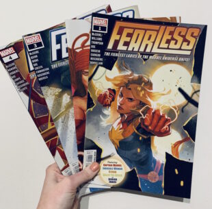Image shows four Fearless issues. Issue most visible to viewer has Captain Marvel illustration. Lightning comes from her fists and she is in combat mode.