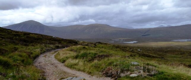 A rough track leading across moorland and into the hills