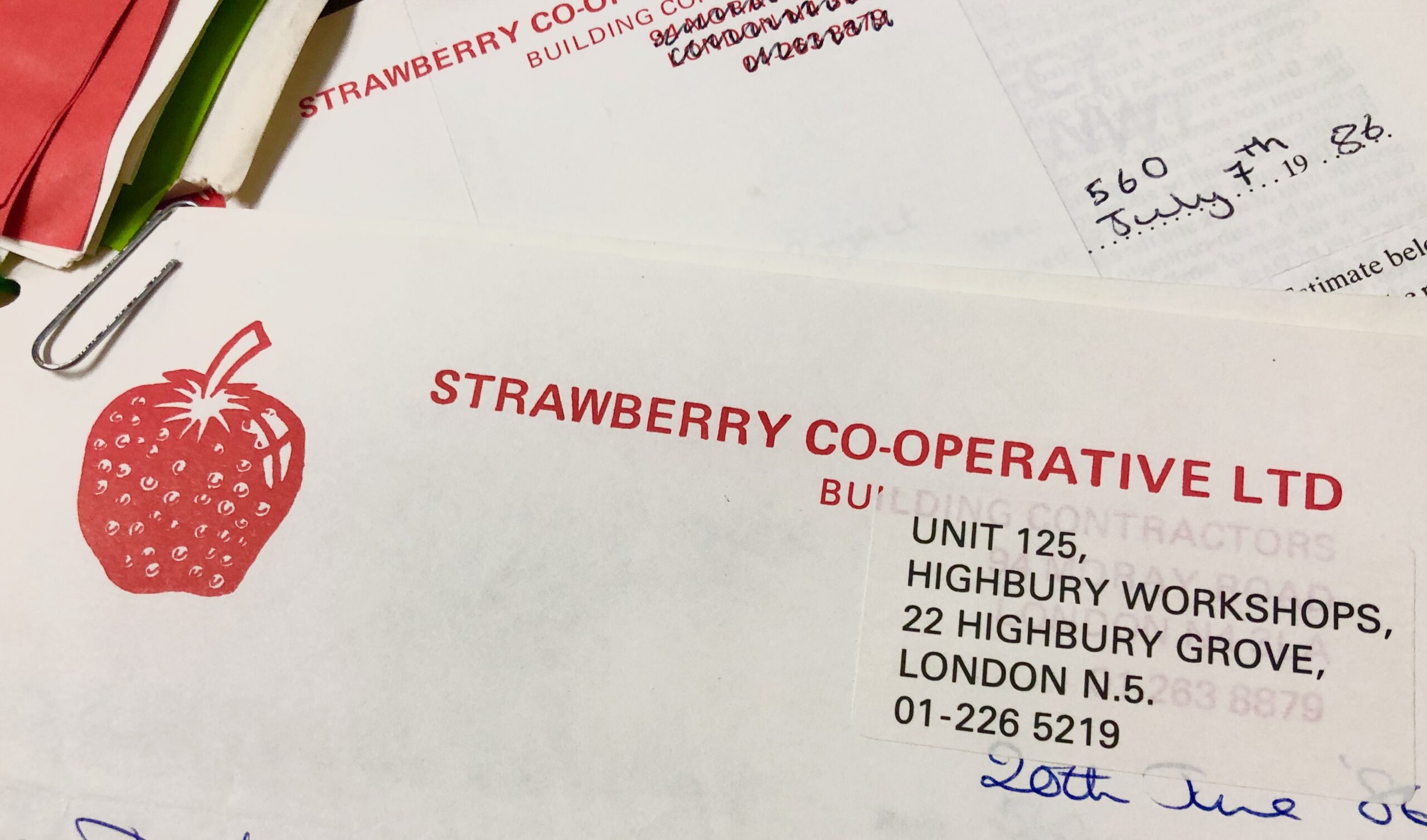 Letterhead of Strawberry Builders Co-operative, featuring their name in bright red all caps block type and to the left of that, a red illustration of a strawberry. 