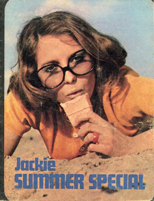Front cover of Jackie Summer Special 1970 depicting a young woman in orange top and black-rimmed glasses lying on the beach