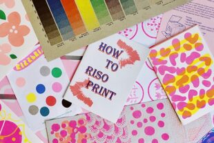 Photo showing a card which reads "How to riso print" surrounded by colourful paper and printed materials