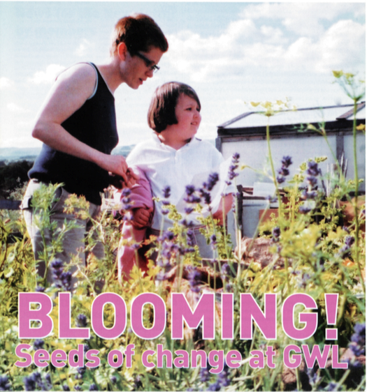front cover of the GWL newletter summer 2003. Shows woman and child in garden surrounded by flowers with the title 'Blooming! seeds of change'. 