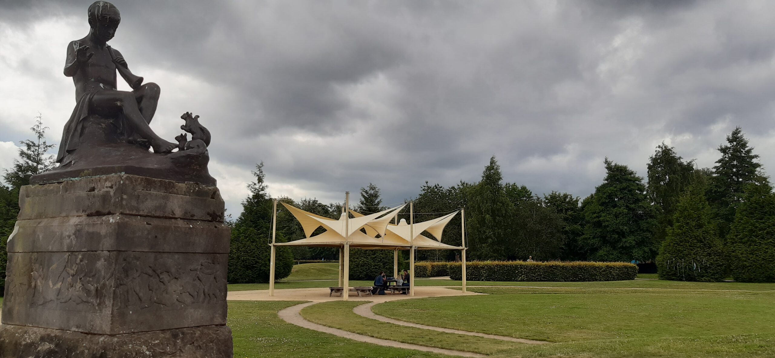 Yellow gazebo on Glasgow Green with statue in foreground