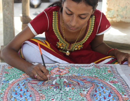 Artist Ritu Kumari Madhubani, painting an elaborate pattern onto fabric