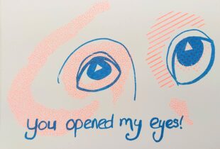 Description: bright orange and blue print depicting wide open eyes and the text “you opened my eyes”