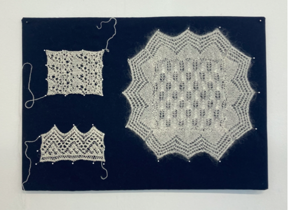 Crochet pieces in white thread on a blue background